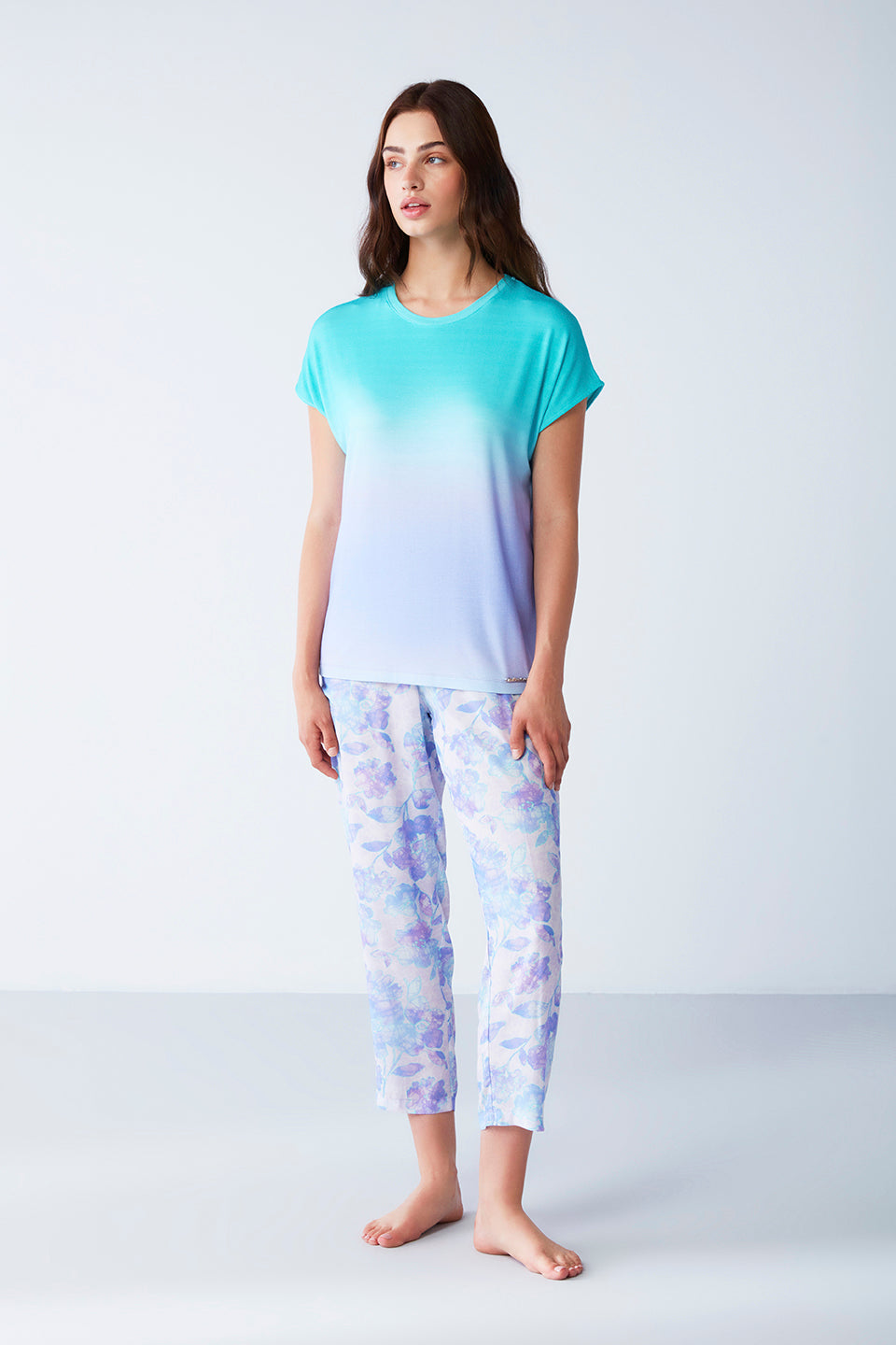 Model wearing Popjammies Women's Pyjama Set with a gradient aqua to lavender top and floral print pants