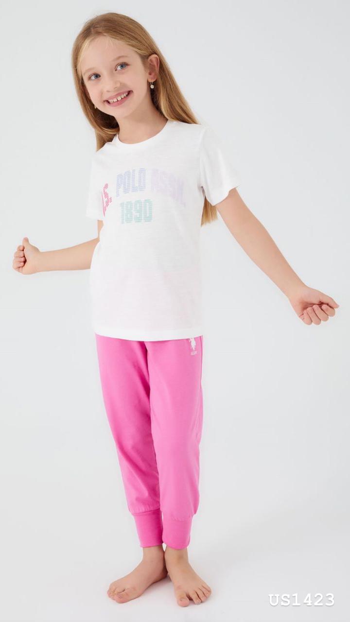 Child wearing the Popjammies Pink Bliss Pajama Set, featuring a white T-shirt with a "U.S. Polo Assn. 1890" graphic and bright pink jogger pants, smiling and looking comfortable.