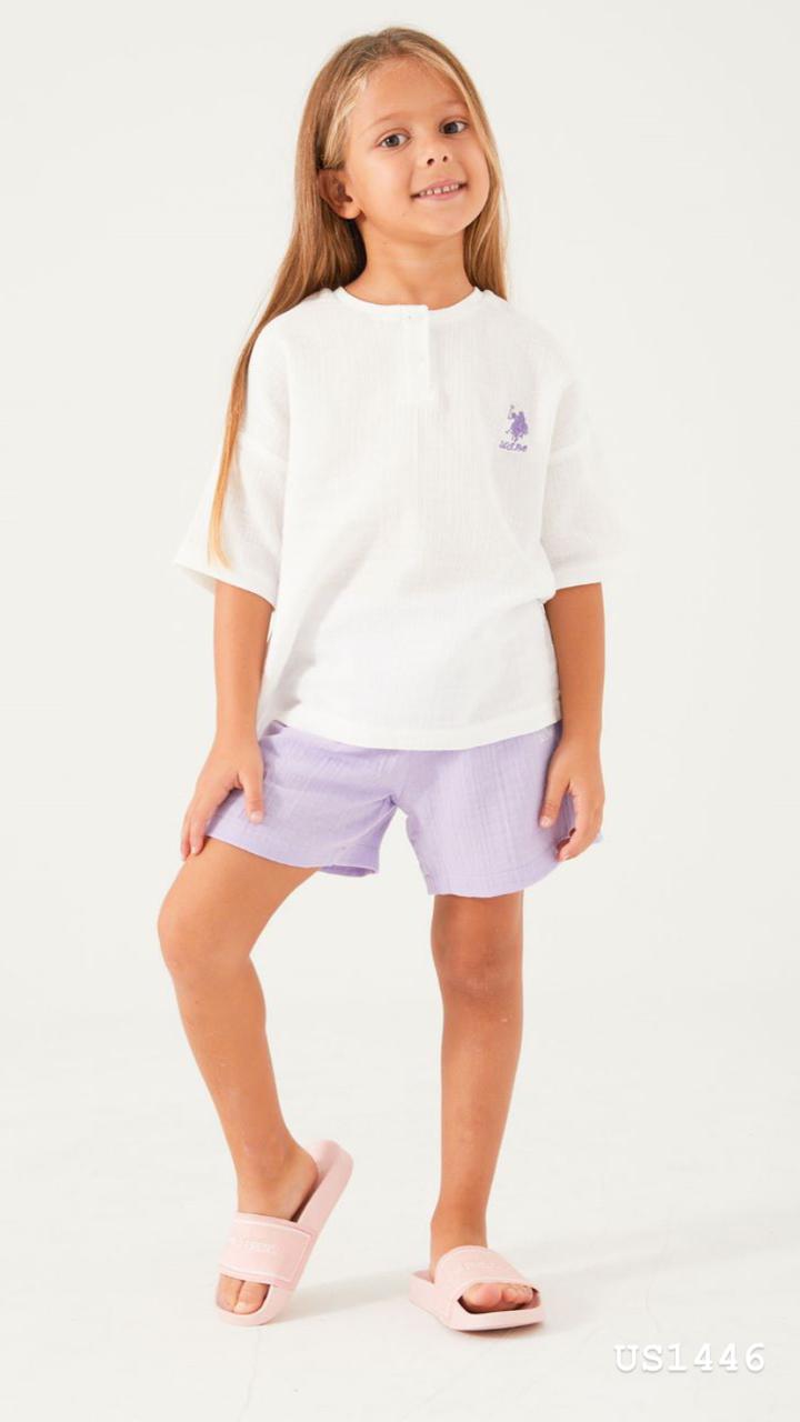 Child wearing the Popjammies Lilac Dream Pajama Set with a white henley top and lilac shorts, looking comfortable and stylish.