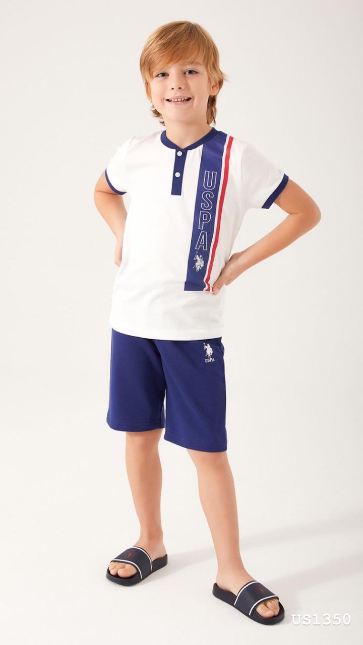 Boy wearing Popjammies White USPA Top with Navy Shorts, smiling and posing with hands on hips.