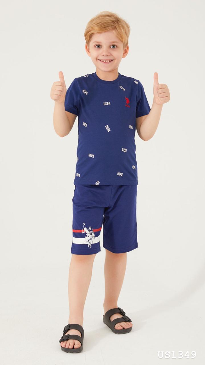 Boy showing off his navy blue pyjama set with USPA pattern on the t-shirt and stylish shorts from Popjammies.