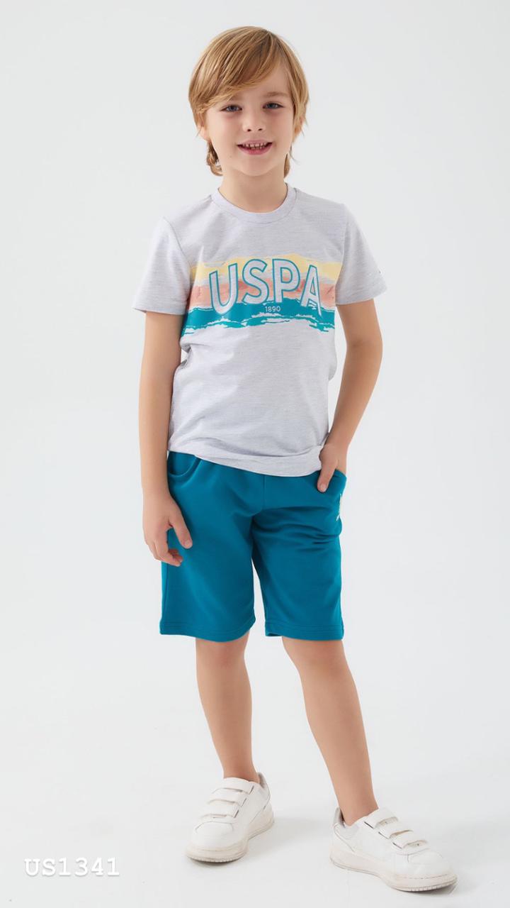 Boy wearing a grey t-shirt with a colorful USPA logo and teal blue shorts from Popjammies pyjama set.