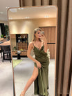 Model taking a mirror selfie wearing an elegant kaki satin evening dress with a thigh-high slit.