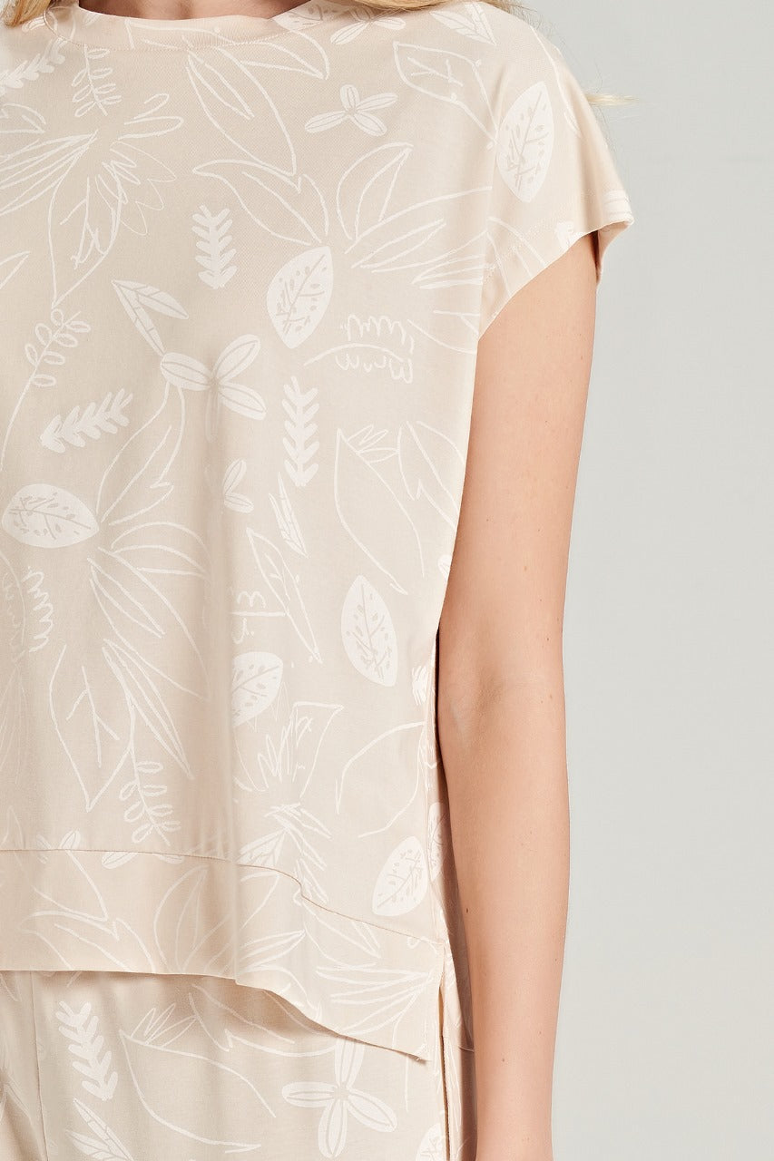 Close-up of the beige floral pajama top, showcasing the delicate floral pattern and cap sleeves.