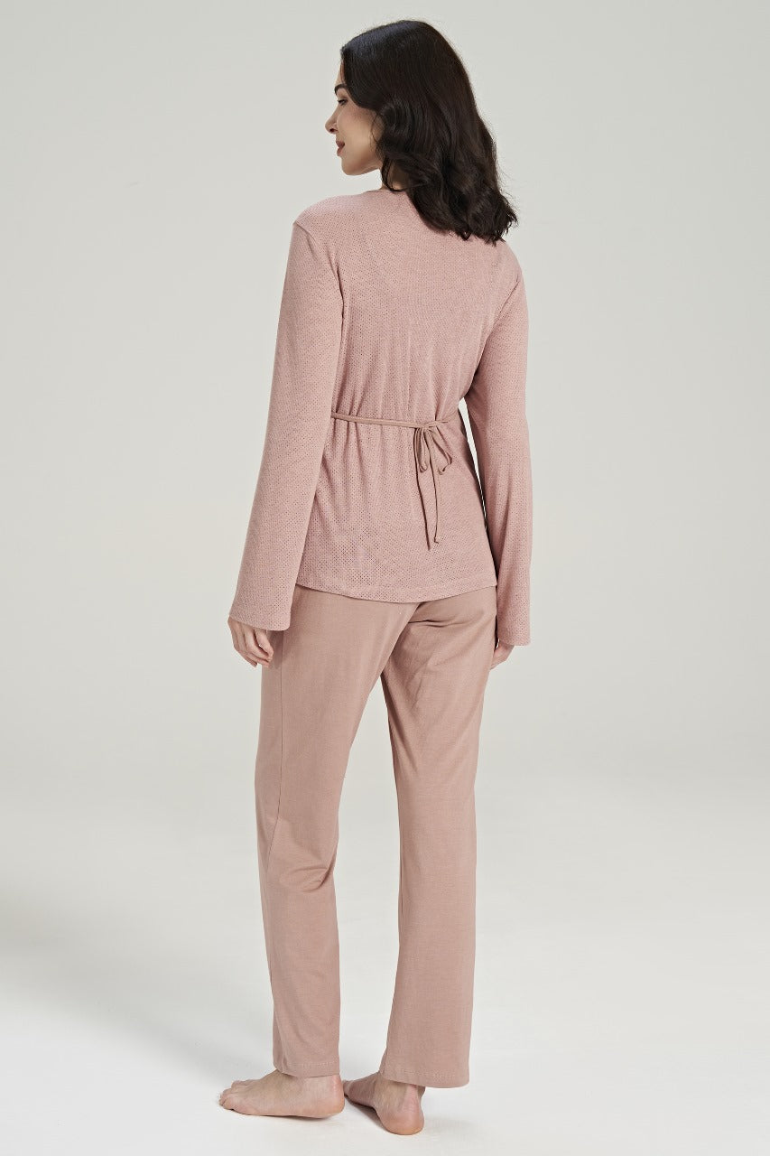 Back view of a model wearing Popjammies Women's Pink Loungewear Set, featuring a long-sleeve top with a tie at the waist and relaxed-fit pants, perfect for comfortable lounging and sleeping.