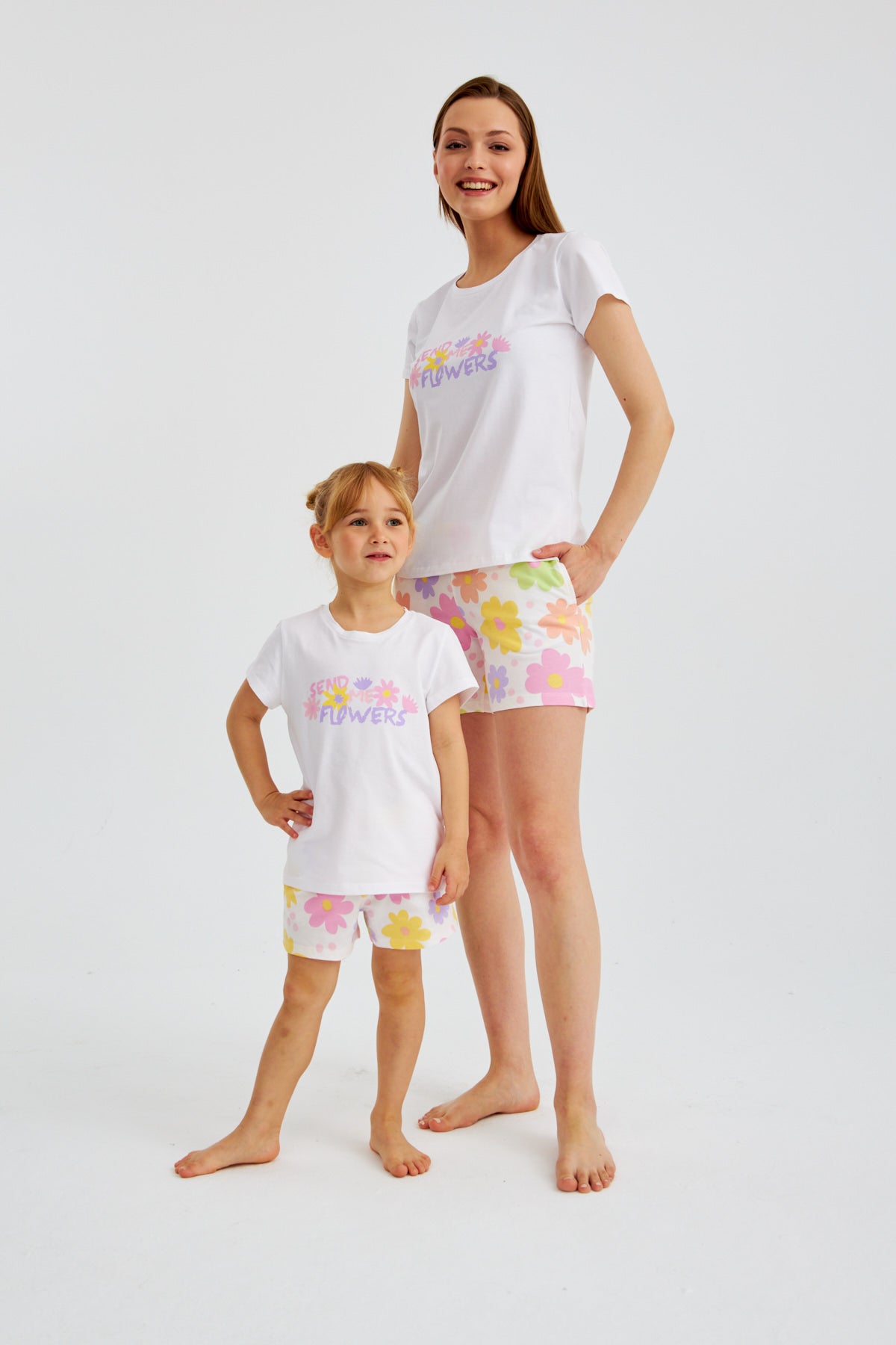  Mother and daughter standing and posing in the Popjammies "Send Me Flowers" pajama set, with their hands on their hips.