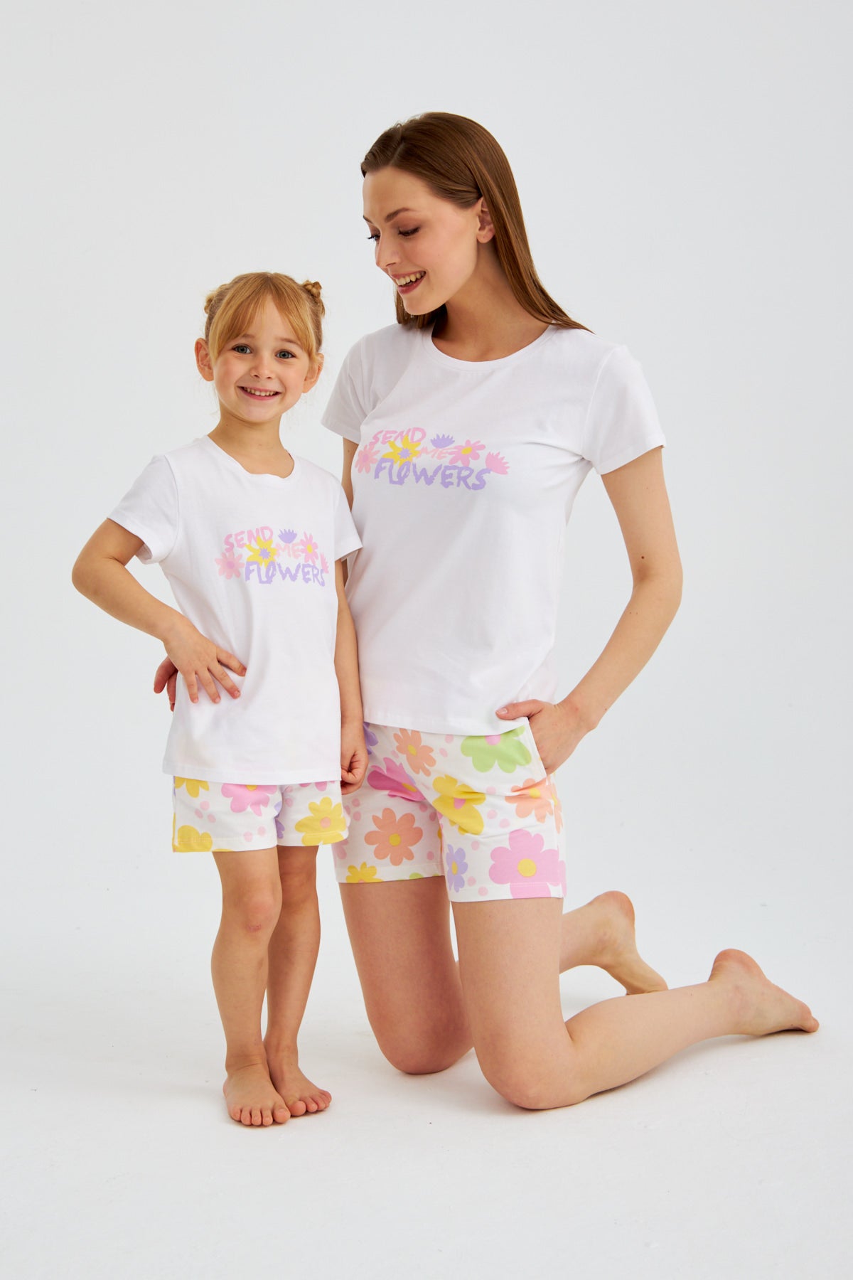 Mother and daughter in matching Popjammies "Send Me Flowers" pajama set, smiling and posing together.