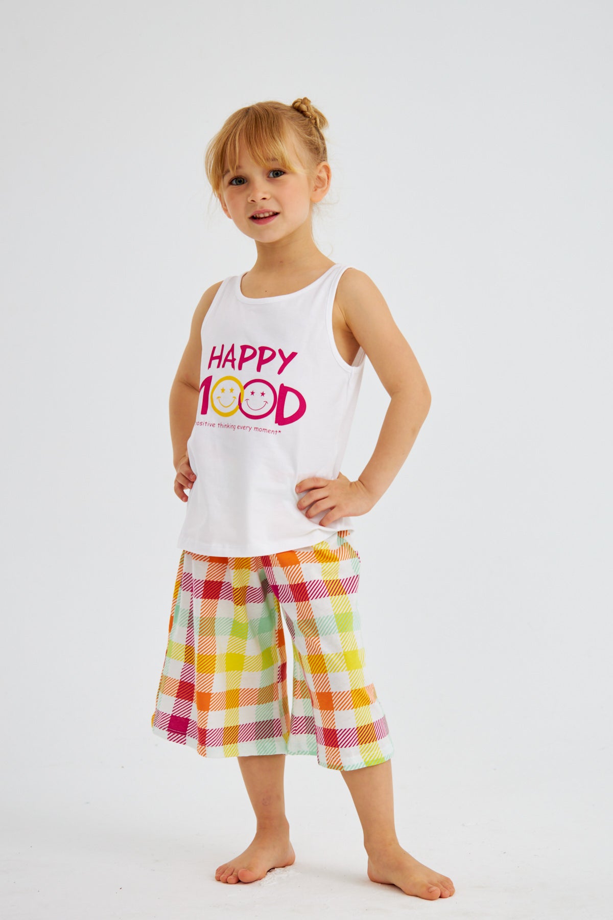  Little girl in "Happy Mood" pyjama set from Popjammies, standing with hands on hips, smiling.