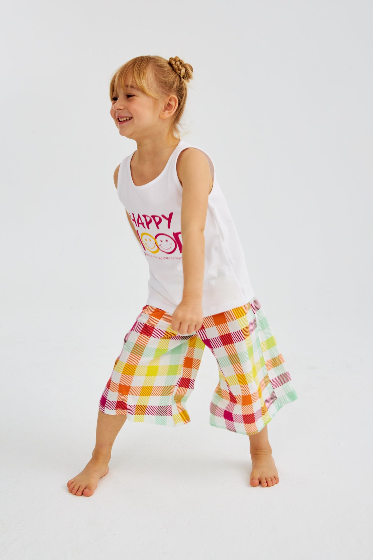 Little girl in "Happy Mood" pyjama set from Popjammies, dancing and having fun.