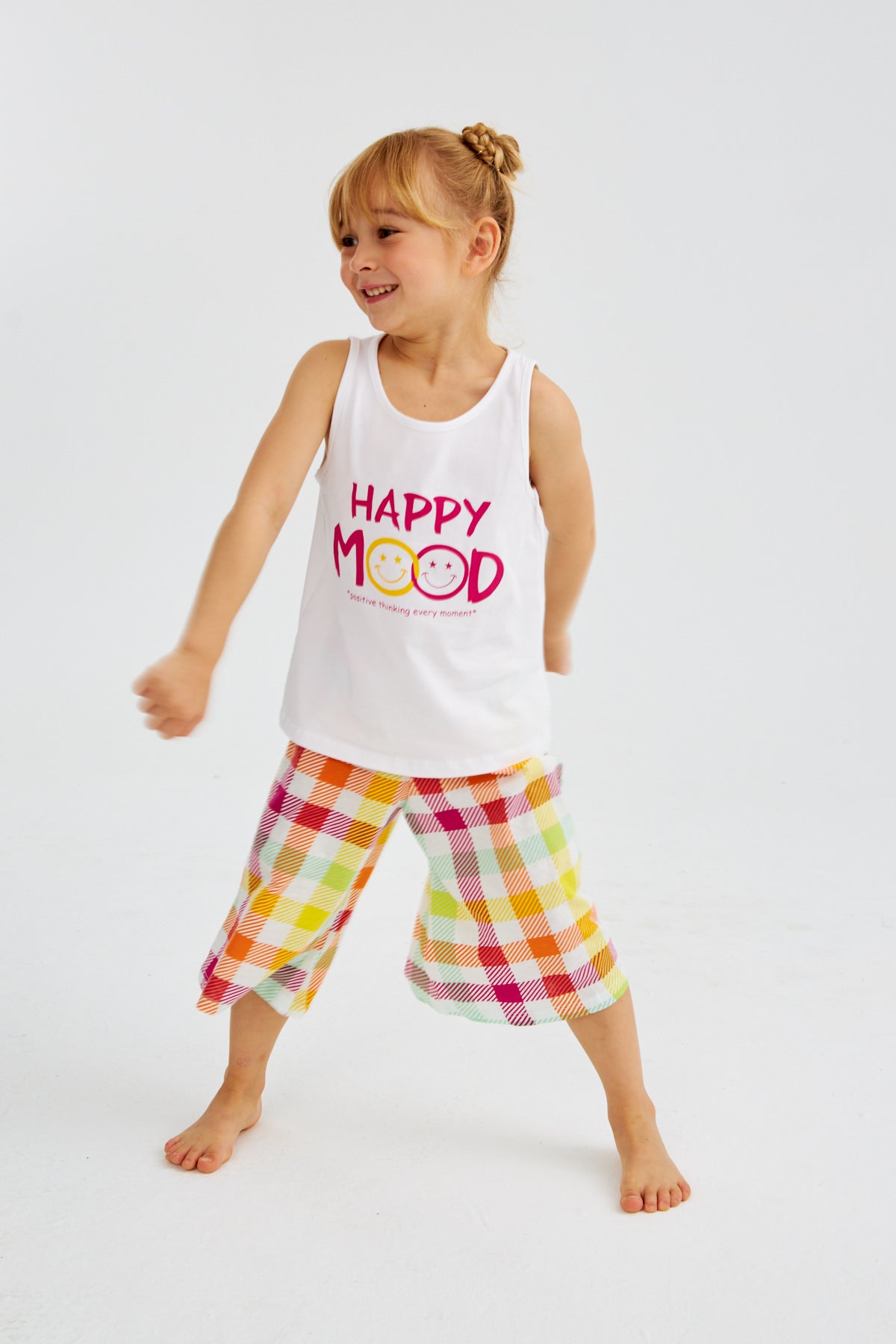 Little girl in "Happy Mood" pyjama set from Popjammies, standing and posing.