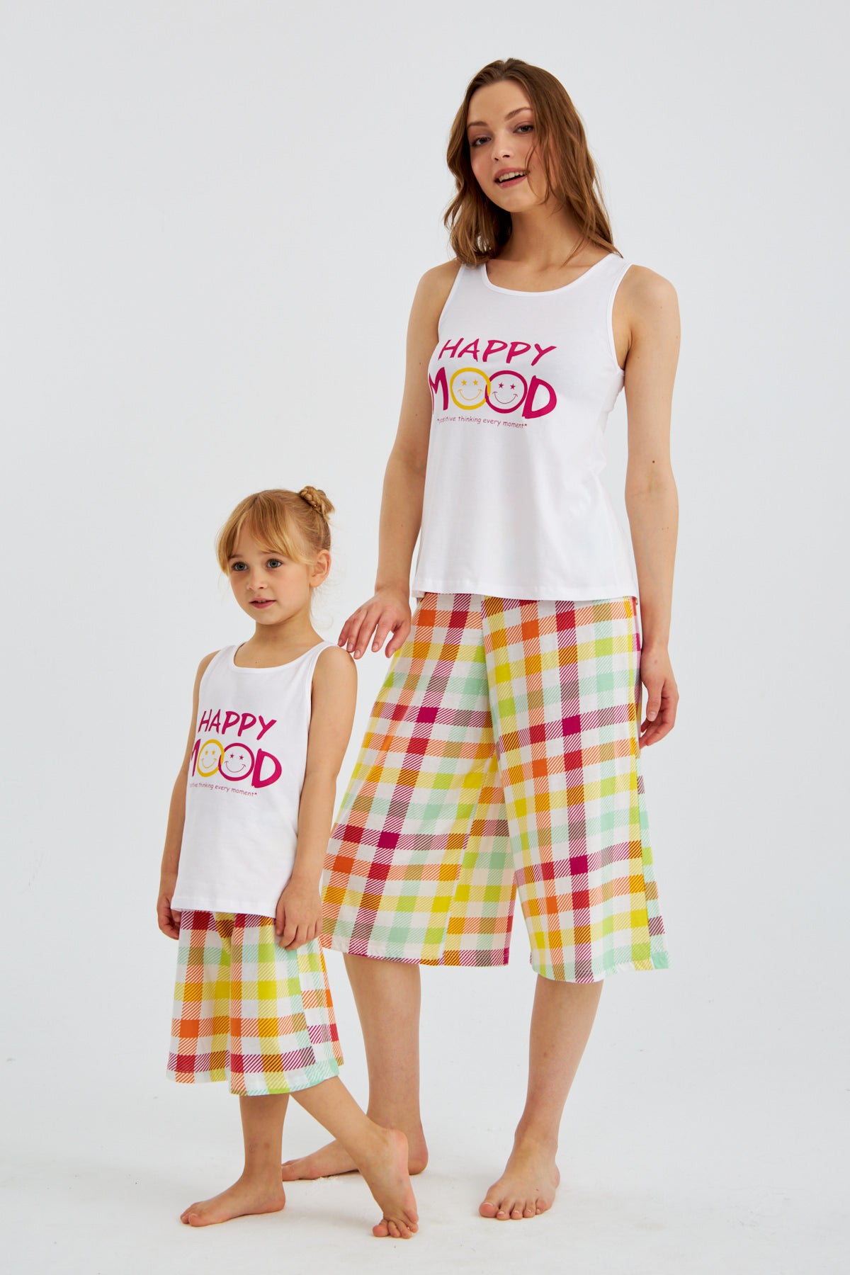 Woman and child wearing matching Popjammies "Happy Mood" Pyjama Sets, standing and smiling.