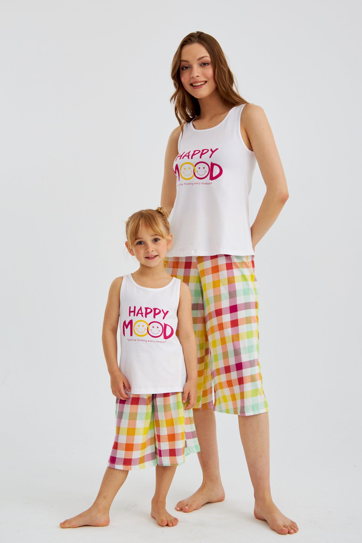 Woman and child wearing matching Popjammies "Happy Mood" Pyjama Sets, standing.