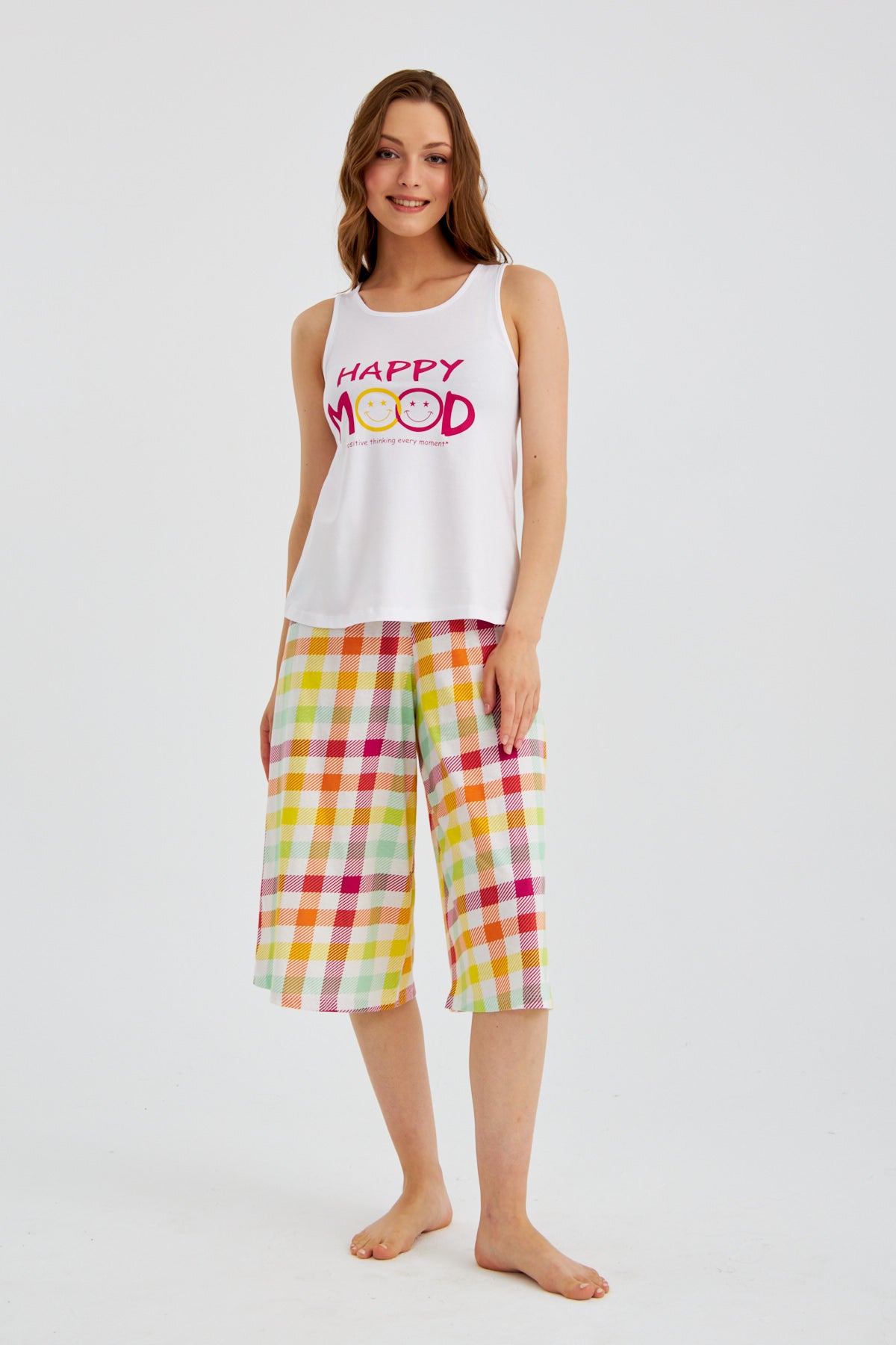 Woman wearing Popjammies "Happy Mood" Pyjama Set, standing and smiling