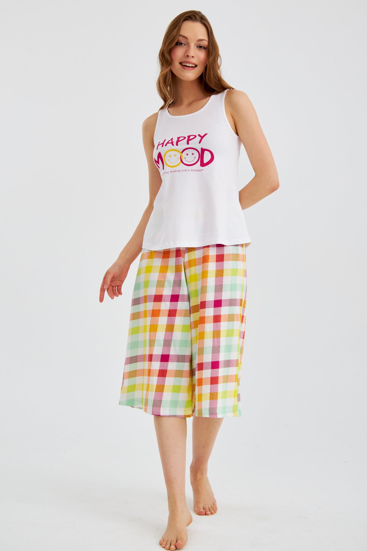 Woman wearing Popjammies "Happy Mood" Pyjama Set, walking and smiling.