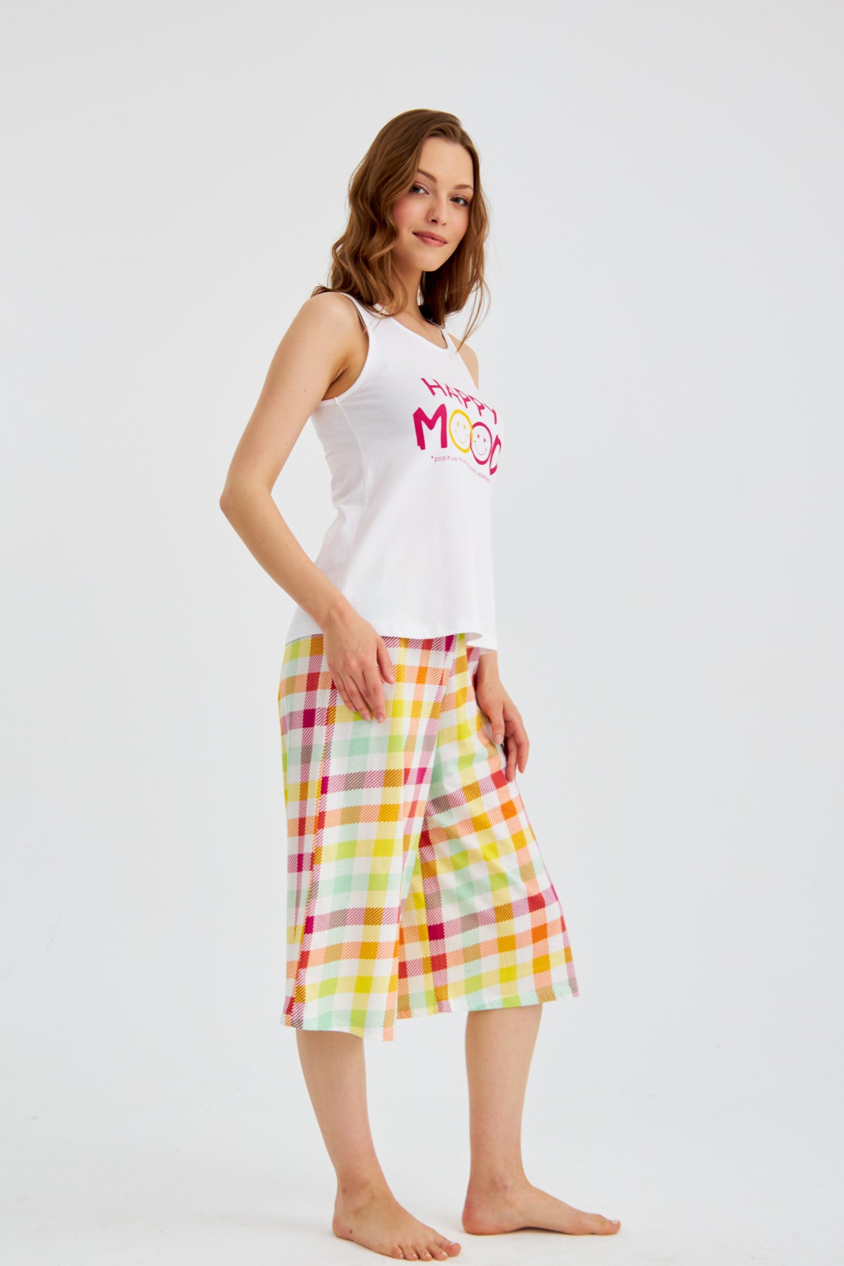 Woman wearing Popjammies "Happy Mood" Pyjama Set, standing and posing sideways.