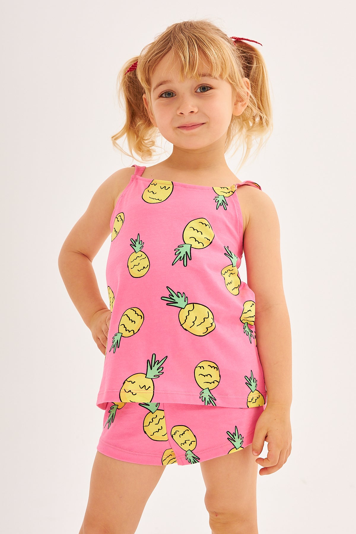 Close-up of the daughter wearing the Popjammies Pineapple Delight Pajama Set, smiling and posing.