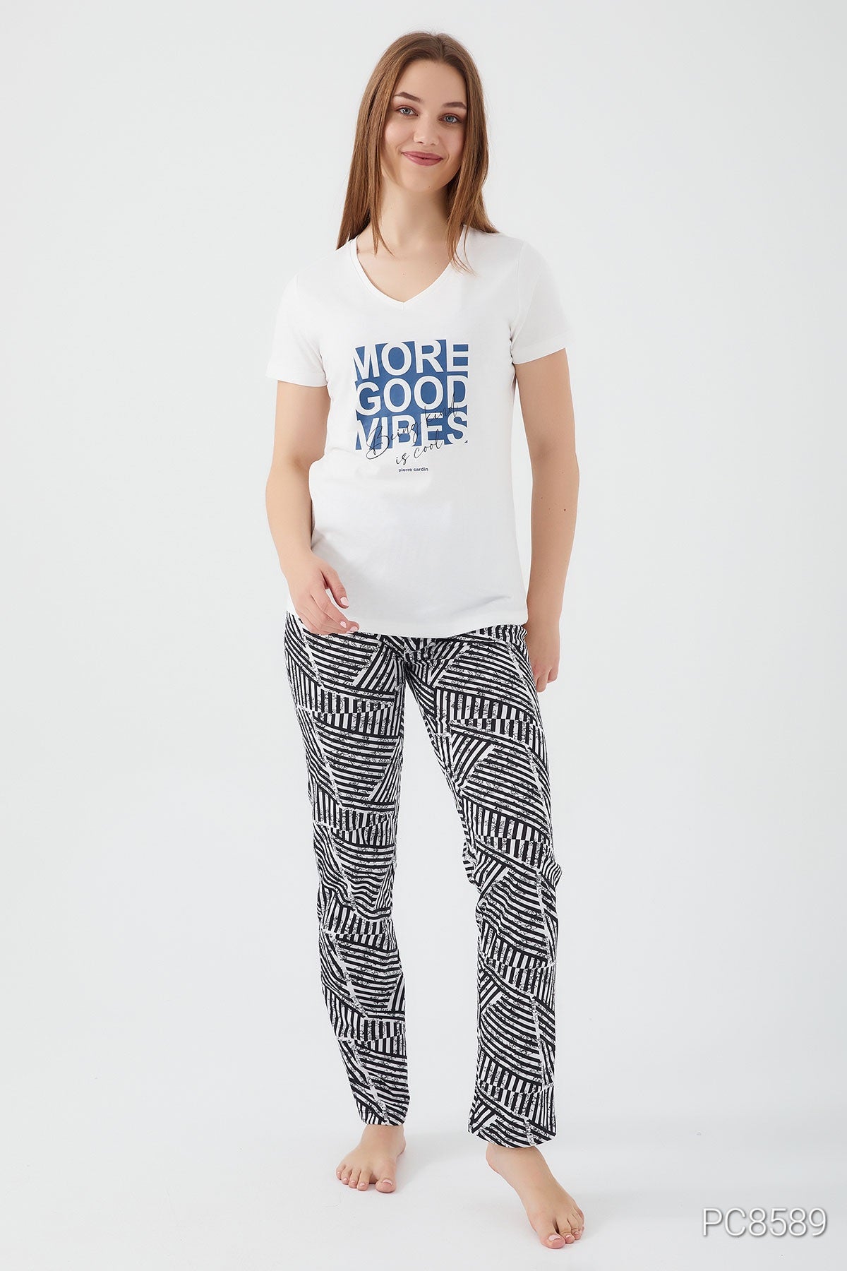 Elegant pyjama set from Popjammies, featuring a stylish button-up top and matching pants, displayed on a bed of soft, cozy fabric.