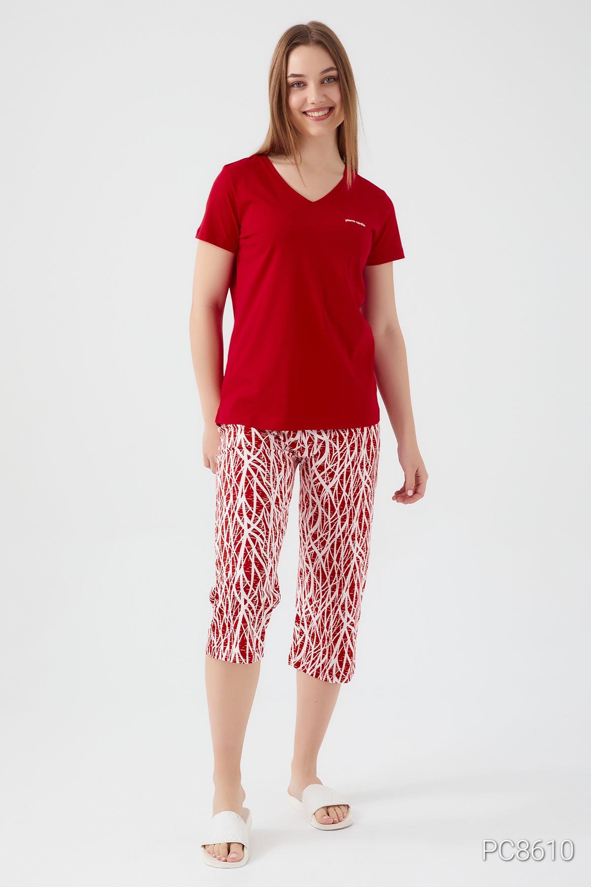 Full view of a woman modeling the Popjammies red short sleeve top and red pantacour with white patterns, perfect for stylish sleepwear.