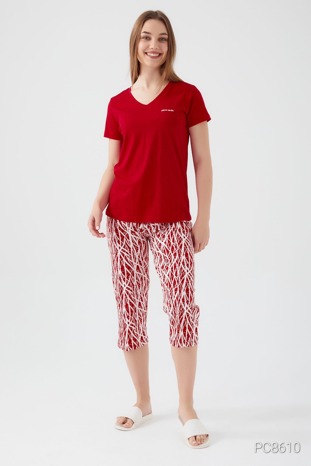 Woman wearing a Popjammies red short sleeve top with matching red pantacour featuring white patterns