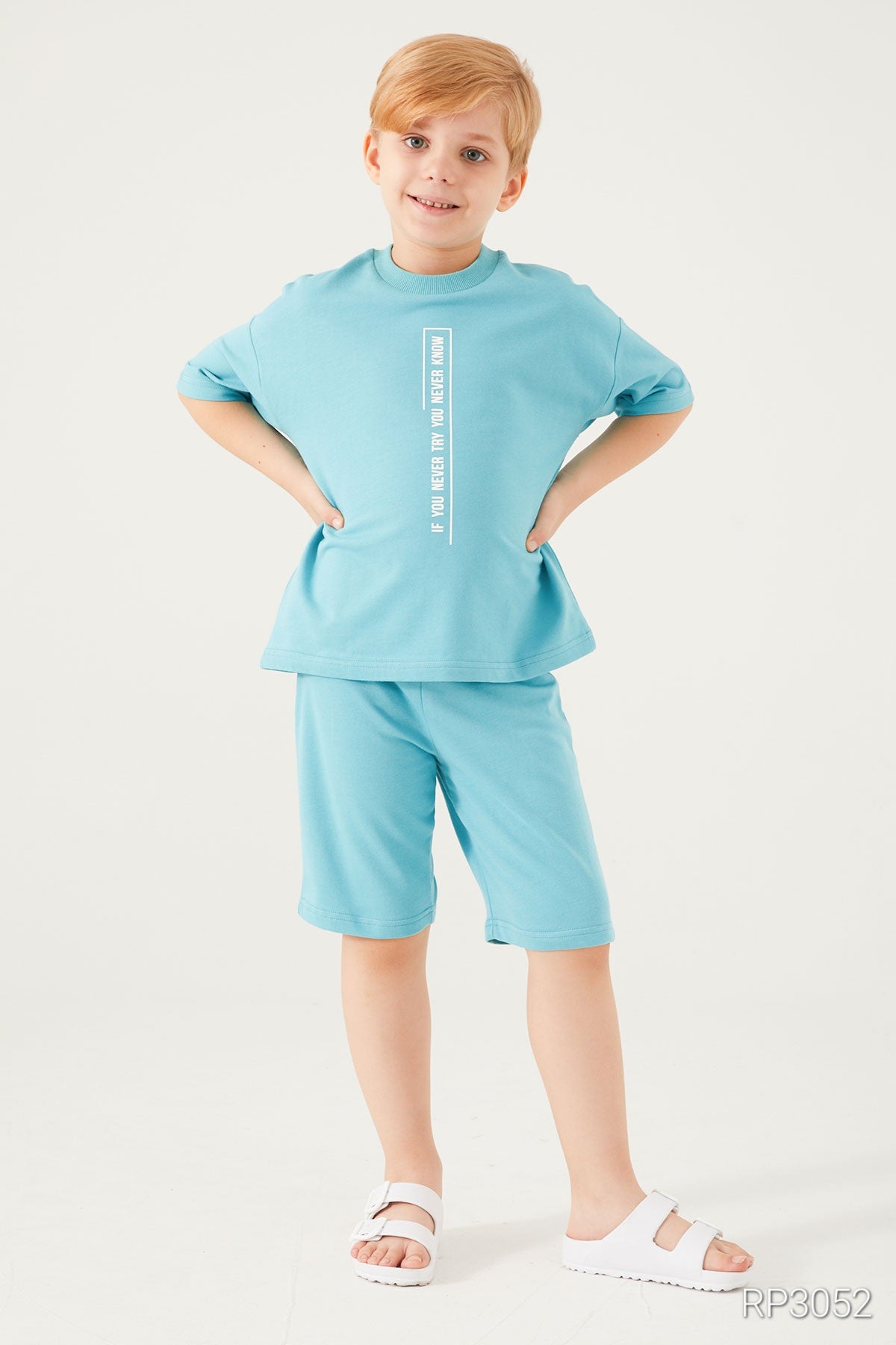 Boy wearing a light blue set from popjammies with hands on hips