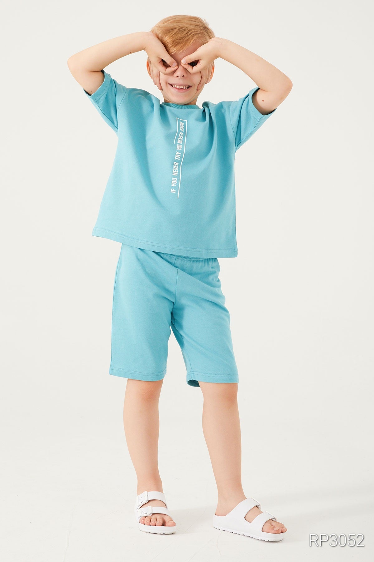 A boy putting his hands on his eyes and wearing the popjammies light blue set