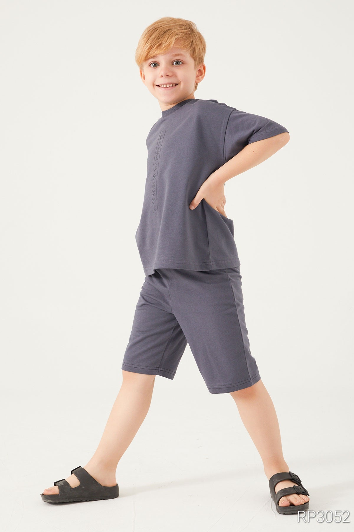 Side view of Popjammies Cozy Dreams Boys' Grey Matching Pyjama Set in ultra-soft cotton, featuring a short-sleeved top and matching shorts.