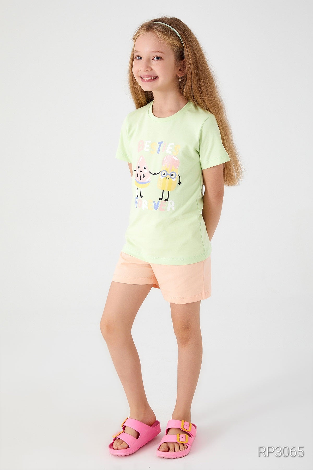 Side view of Popjammies 'Friends Forever' Pajama Set featuring a light green top with 'Friends Forever' text and ice cream graphic, paired with pastel-colored shorts.