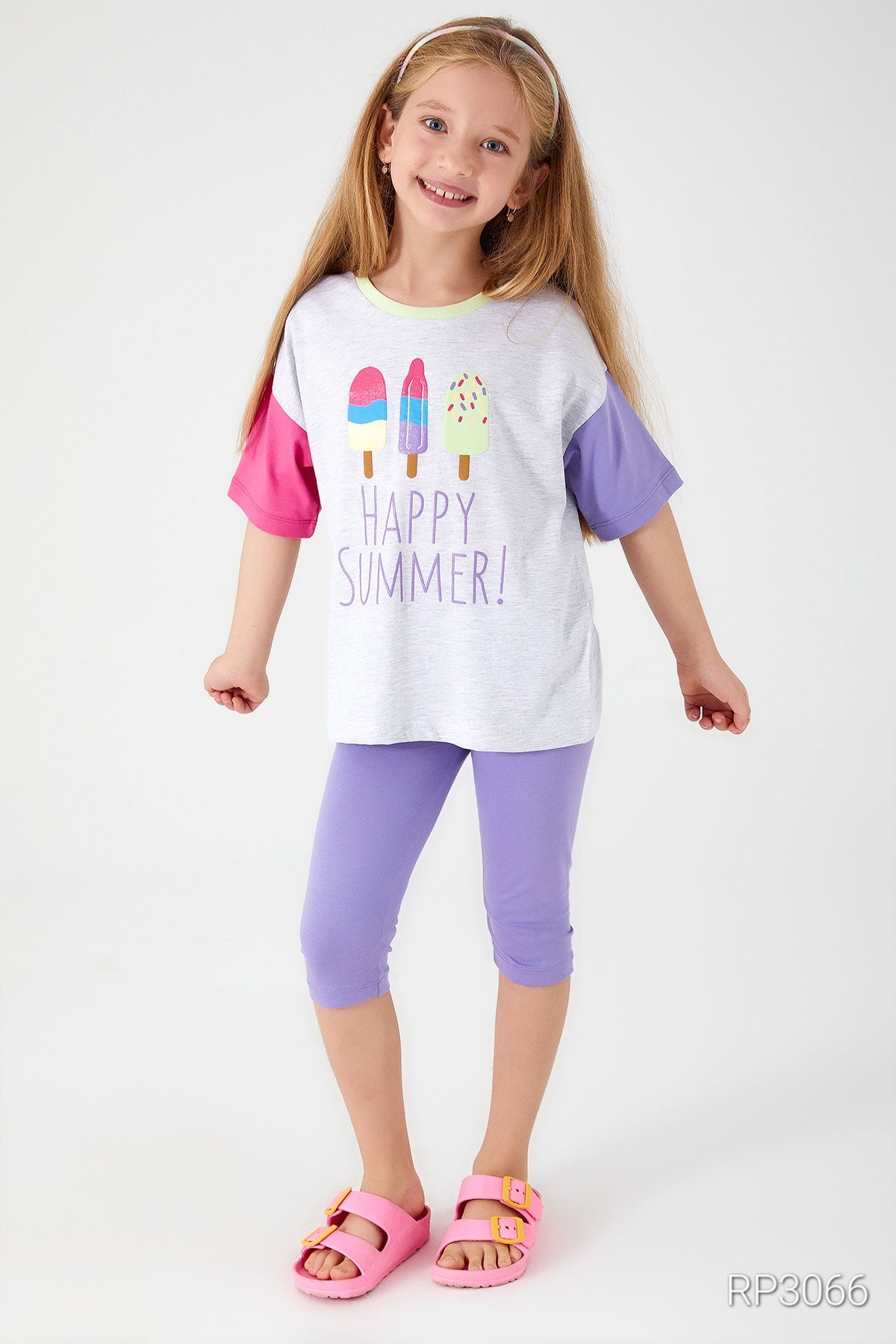 Front view of Popjammies 'Happy Summer' Pajama Set featuring a grey top with 'Happy Summer' text and ice cream graphic, with one pink sleeve and one purple sleeve, paired with purple short leggings with open hands