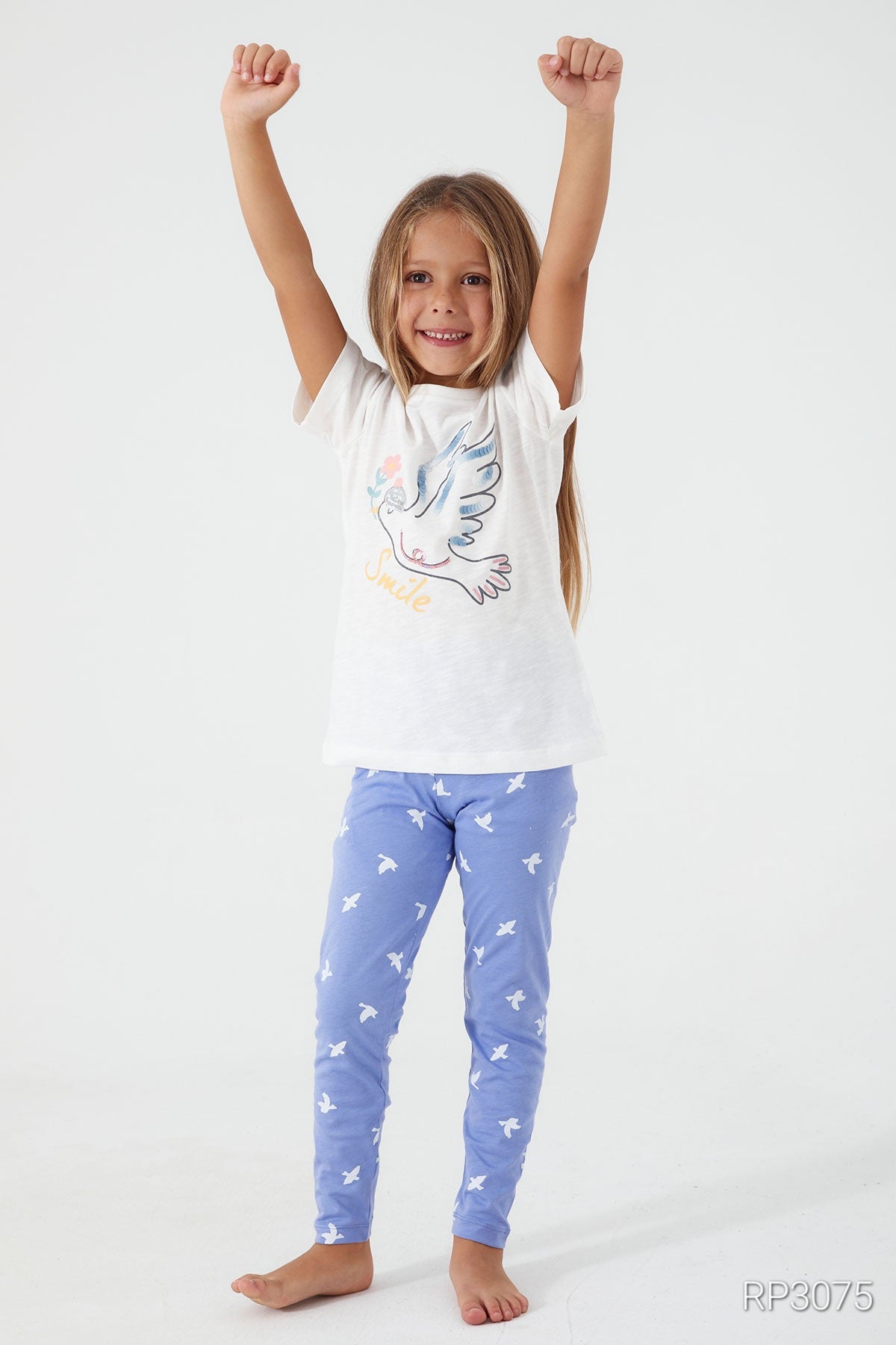 Girl wearing Popjammies Birdie Bliss Pajama Set with white top and blue pants , hands up