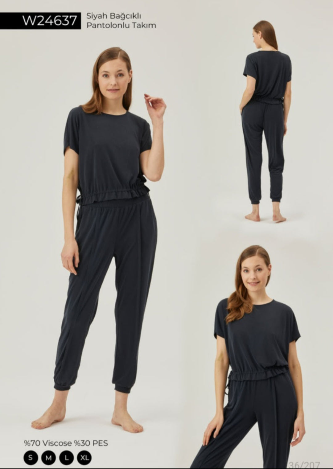 Model wearing Popjammies Black Drawstring Lounge Set featuring a comfortable cinched waist top and tapered pants, ideal for both lounging and casual wear.