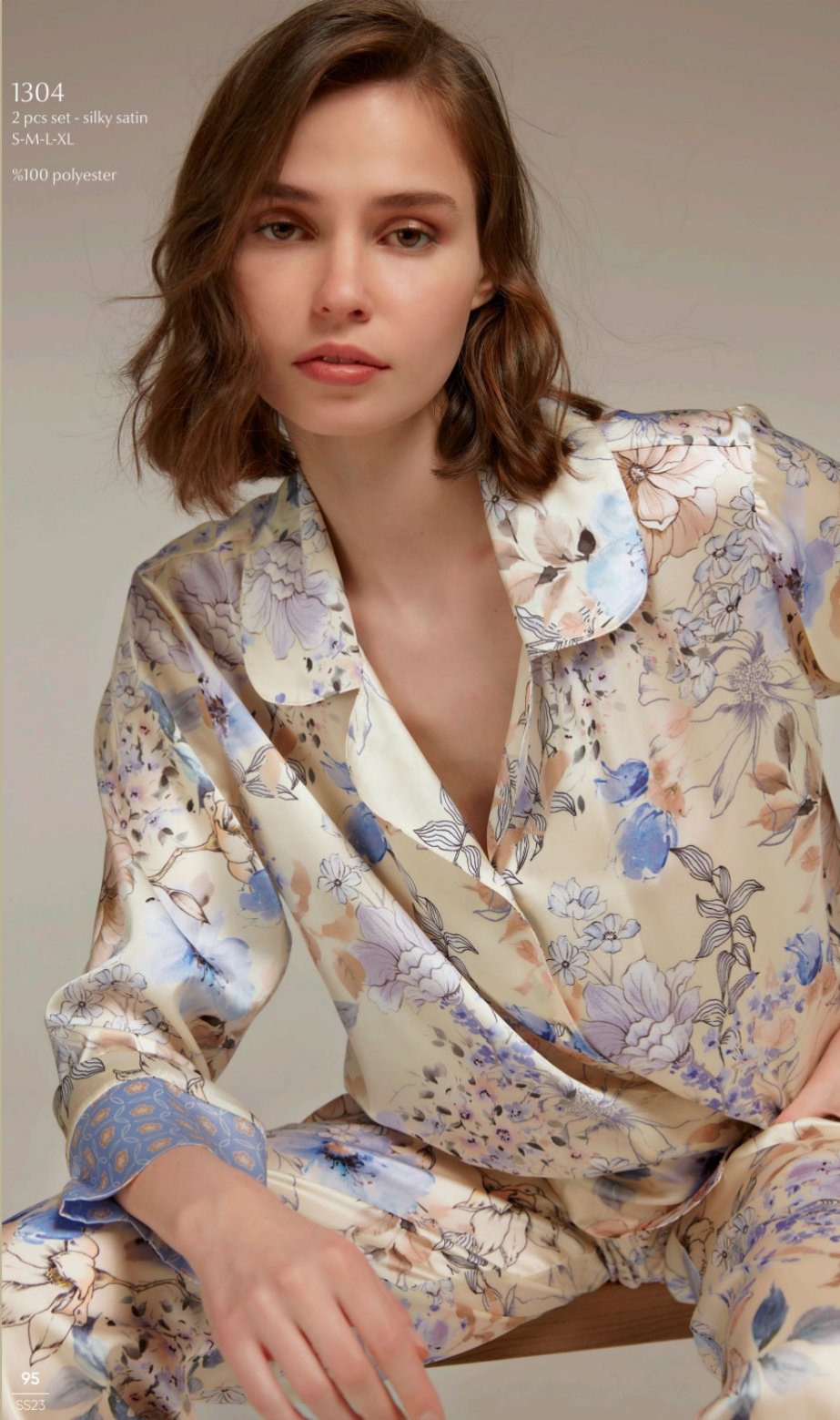 Model wearing Popjammies 1304 Two-Piece Silky Satin Floral Pyjama Set, featuring a button-down top with a classic collar and matching pants, both in a luxurious floral print.