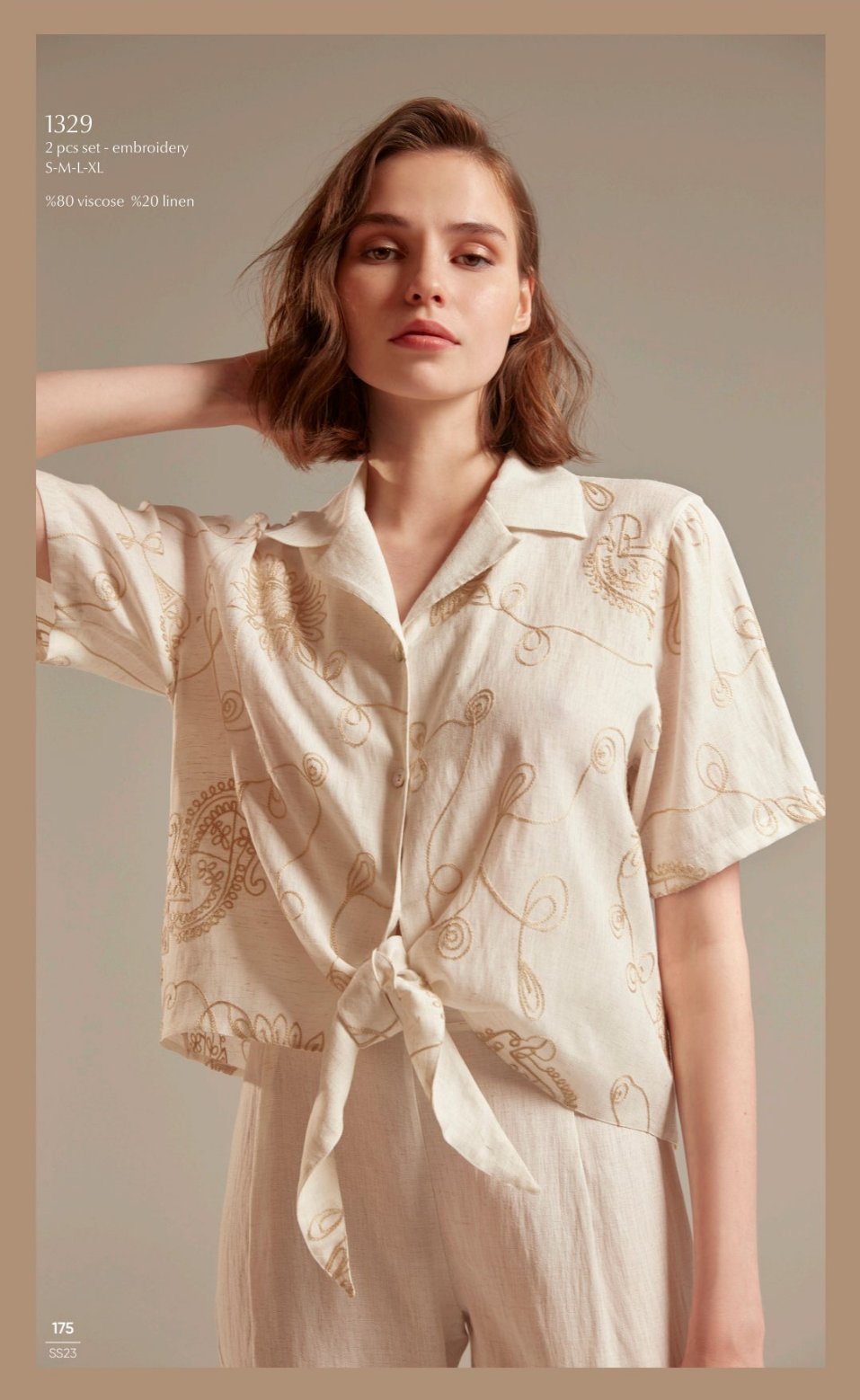 Model wearing Popjammies 1329 Two-Piece Embroidered Pyjama Set in cream, featuring a tie-front top with intricate embroidery.