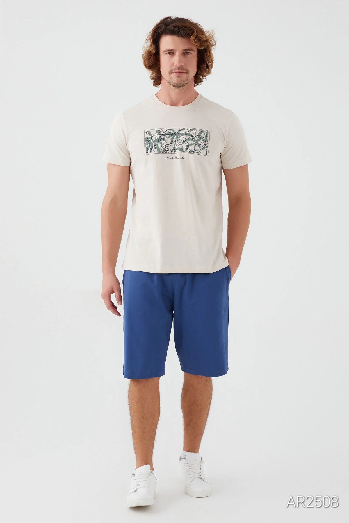 A white pajama top with short sleeves, featuring a subtle design and relaxed fit, shown on a man.