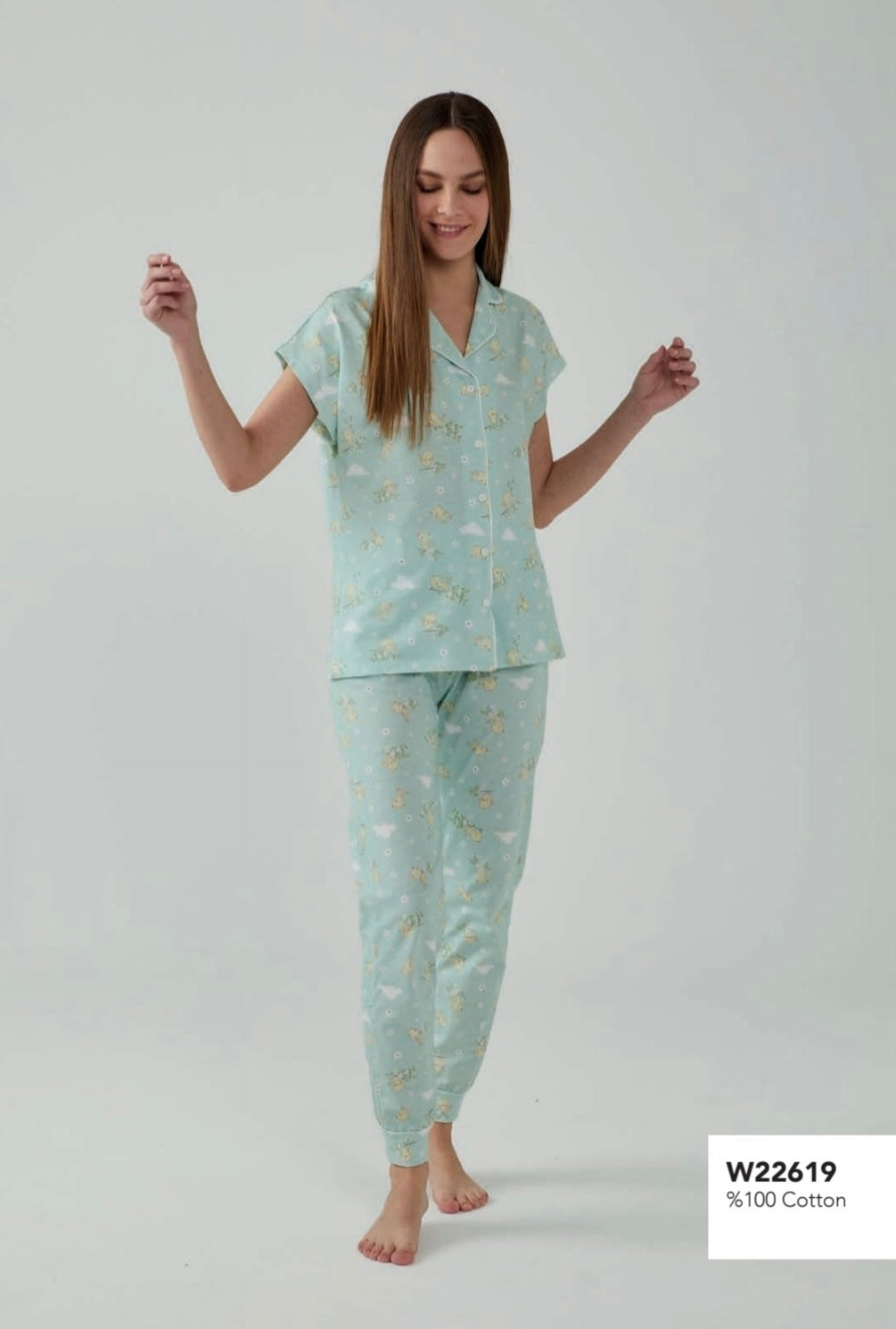 Model wearing a Popjammies mint floral button-down pyjama set, featuring a short-sleeve top and matching pants, walking barefoot.