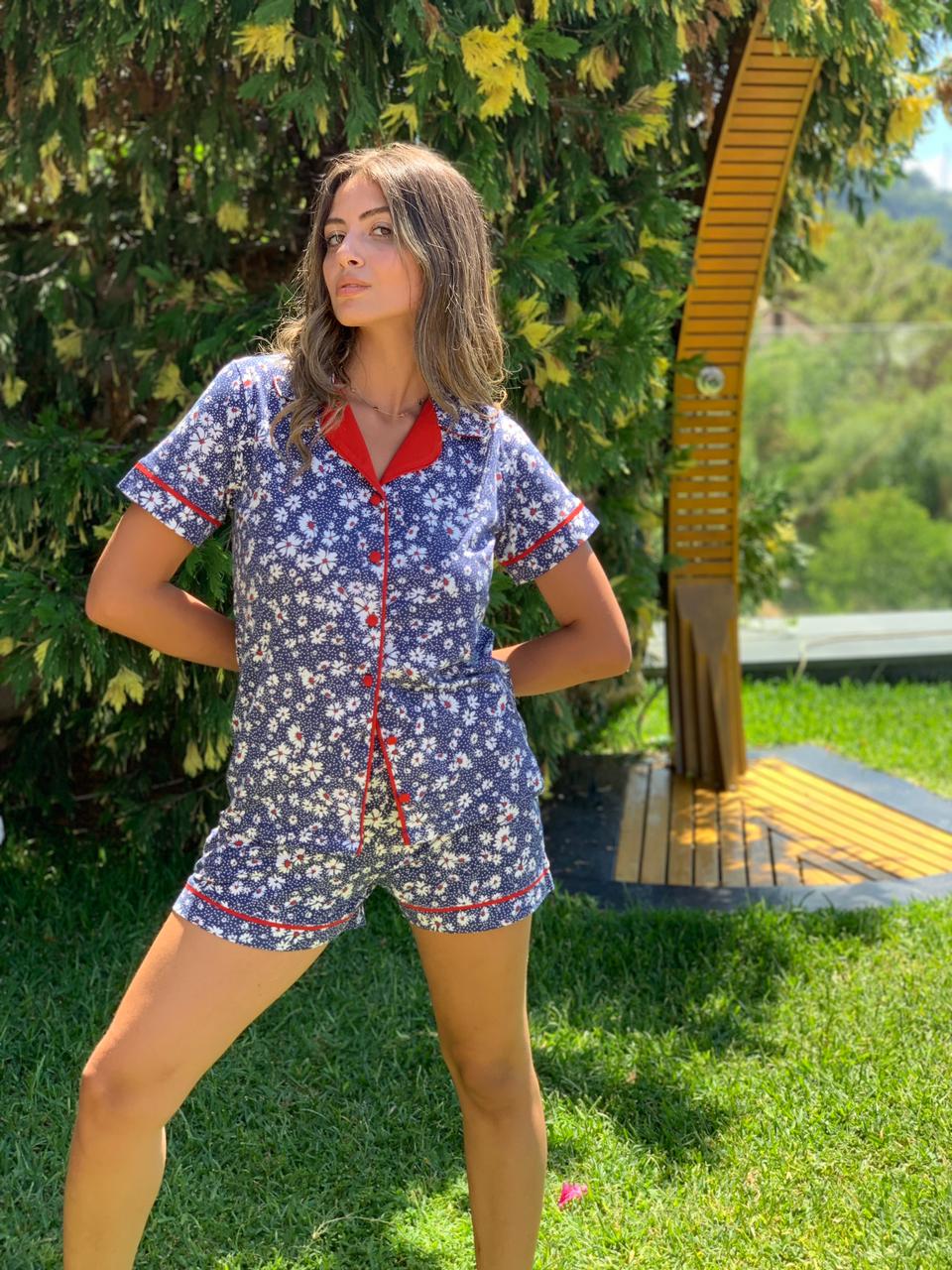 Woman showcasing the floral print details of Popjammies Pajama Set in a garden.