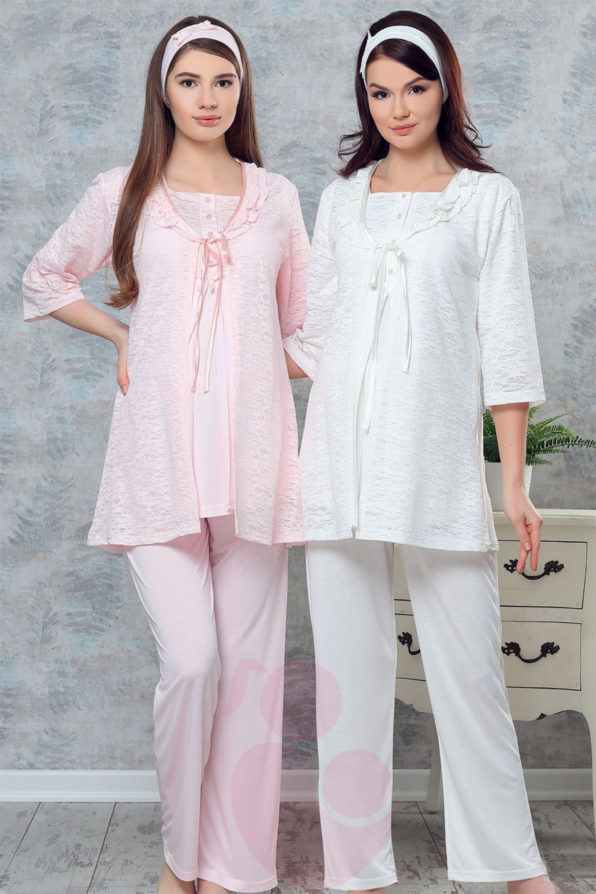 Two pregnant women wearing Popjammies Lace Trim Maternity Pajama Sets, one in pink and one in white, featuring lace trim tops and matching pants.