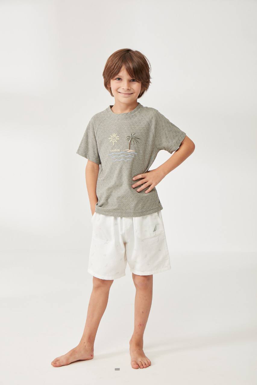 Boy wearing a grey t-shirt with an embroidered beach scene and white shorts from Popjammies.